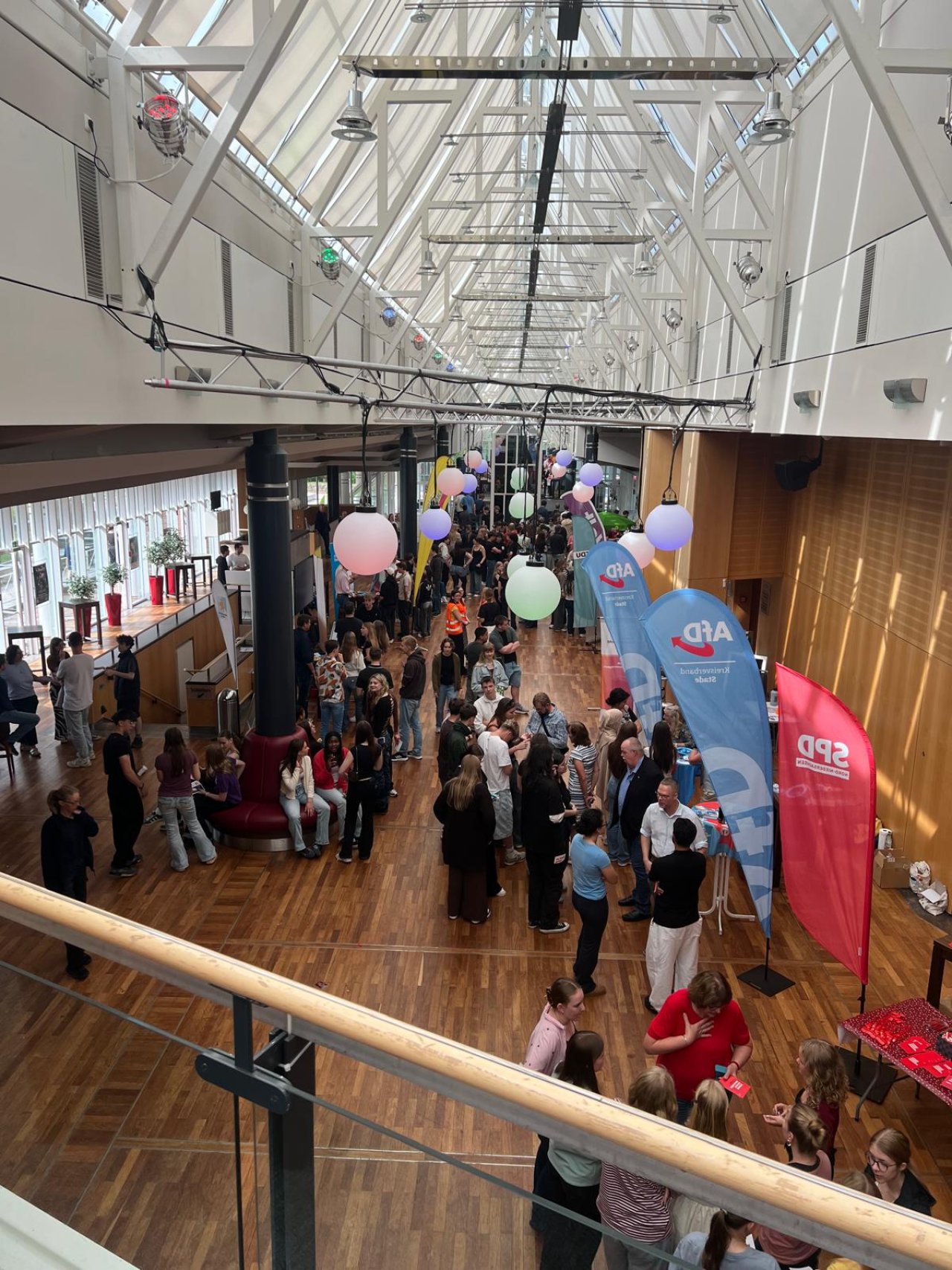 Blick von der Treppe auf die Informationsstände im Foyer.